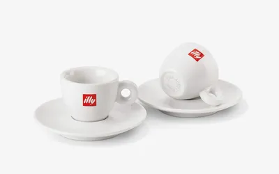 Two illy Logo espresso cups with saucers, 90 ml white porcelain, one upturned to show its base